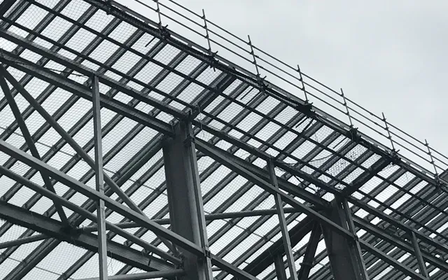 Perimeter edge protection and safety netting on a steel-frame roof structure